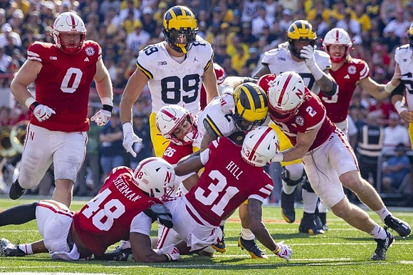 AJ Barner (89), Blake Corum (2), and Trevor Keegan (77)