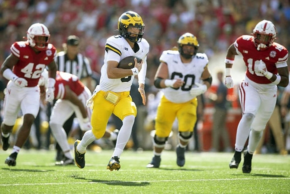 J.J. McCarthy (9) and Drake Nugent (60)
