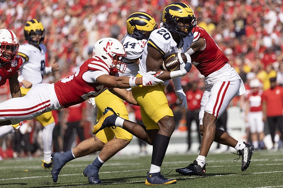 J.J. McCarthy (9), Max Bredeson (44), and Kalel Mullings (20)