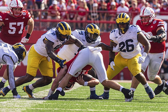 Derrick Moore (8), Cam Goode (99), and Rayshaun Benny (26)