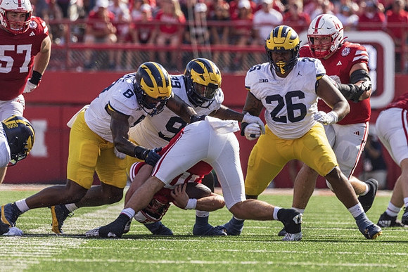 Derrick Moore (8), Cam Goode (99), and Rayshaun Benny (26)