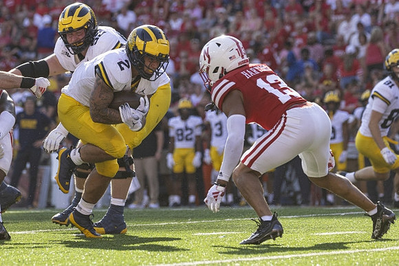 Karsen Barnhart (52), Blake Corum (2), and Peyton O'Leary (81)