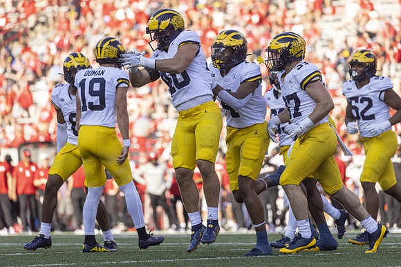 Tommy Doman (19) and Michigan Team