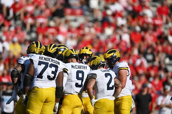 LaDarius Henderson (73), J.J. McCarthy (9), and Blake Corum (2)