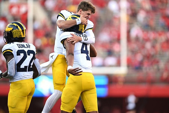 Tavierre Dunlap (22), J.J. McCarthy (9), and Jayden Denegal (4)