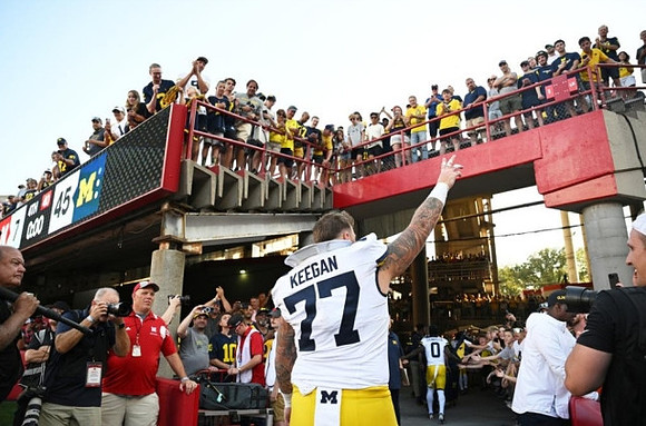 Trevor Keegan (77) and Mike Sainristil (0)
