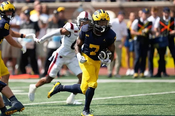 Peyton O'Leary (81) and Donovan Edwards (7)