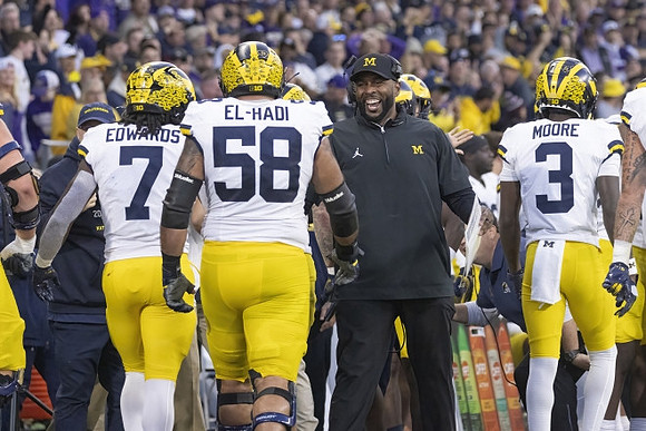 Donovan Edwards (7), Giovanni El-Hadi (58), Sherrone Moore, and Fredrick Moore (3)