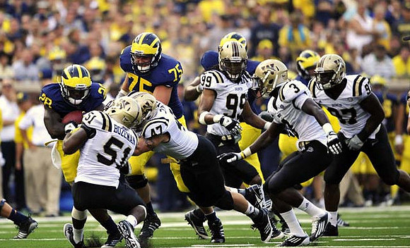 Fitzgerald Toussaint (28) and Michael Schofield (75)