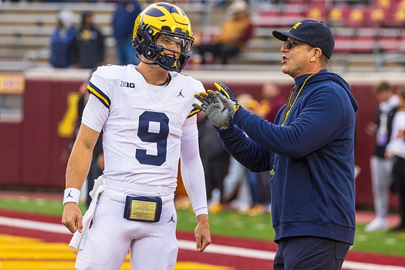J.J. McCarthy (9) and Jim Harbaugh