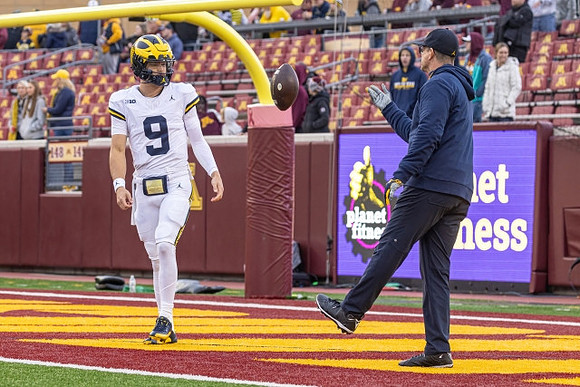 J.J. McCarthy (9) and Jim Harbaugh