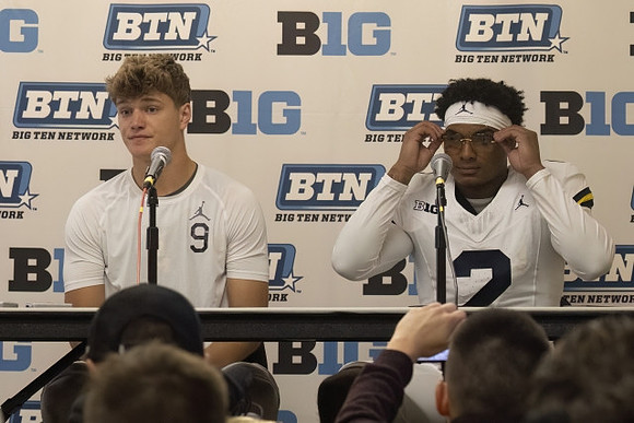 J.J. McCarthy (9) and Will Johnson (2)
