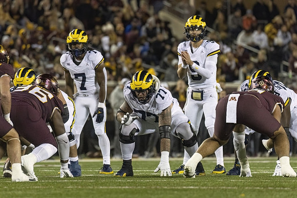Donovan Edwards (7), Trevor Keegan (77), J.J. McCarthy (9), and LaDarius Henderson (73)