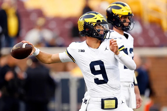 J.J. McCarthy (9) and Jack Tuttle (13)