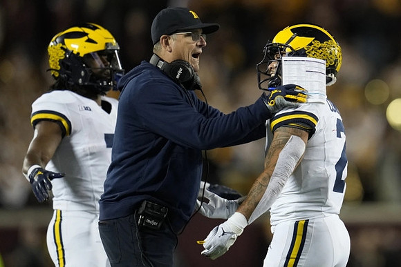 Donovan Edwards (7), Jim Harbaugh, and Blake Corum (2)