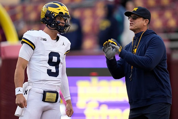 J.J. McCarthy (9) and Jim Harbaugh