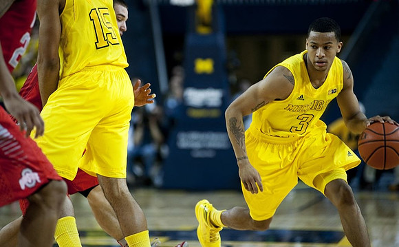 Jon Horford (15) and Trey Burke (3)