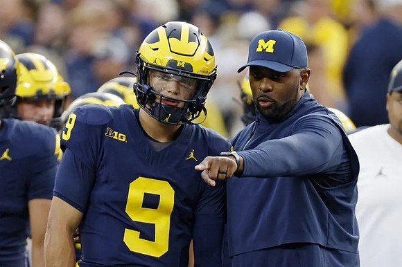J.J. McCarthy (9) and Sherrone Moore