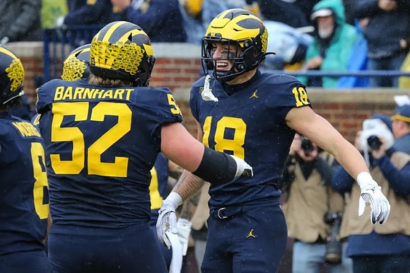 Tyler Morris (8), Karsen Barnhart (52), and Colston Loveland (18)