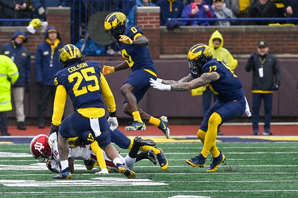 Junior Colson (25), Mike Sainristil (0), and Braiden McGregor (17)