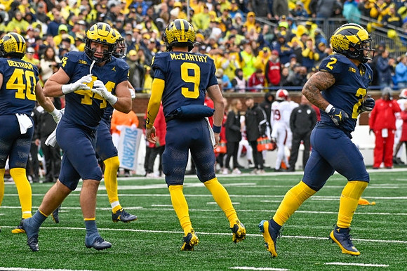 Christian Boivin (40), Max Bredeson (44), J.J. McCarthy (9), and Blake Corum (2)