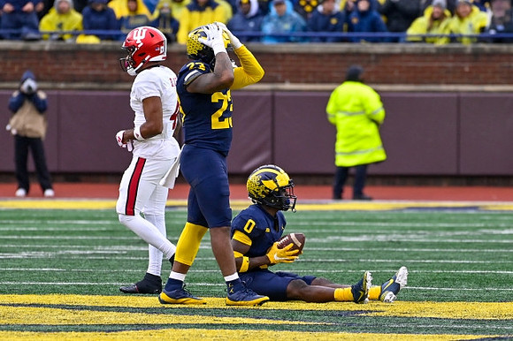 Michael Barrett (23) and Mike Sainristil (0)