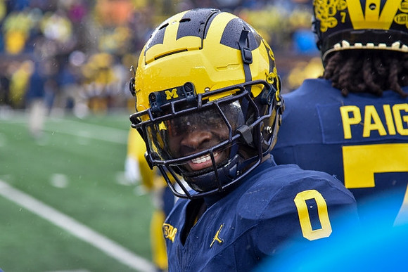 Mike Sainristil (0) and Makari Paige (7)