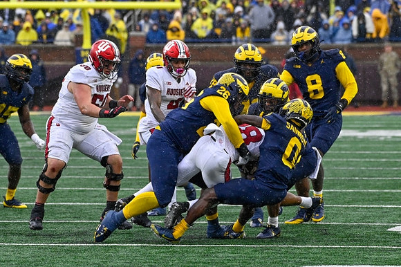 Ernest Hausmann (15), Kenneth Grant (78), Rayshaun Benny (26), Mike Sainristil (0), and Derrick Moore (8)