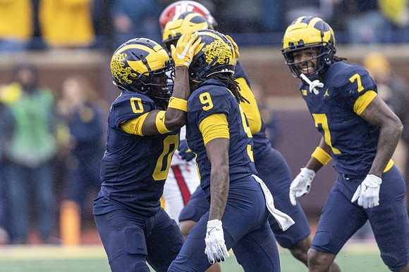 Mike Sainristil (0), Rod Moore (9), and Makari Paige (7)