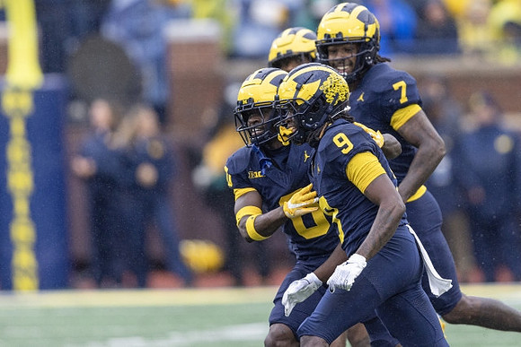 Mike Sainristil (0), Rod Moore (9), and Makari Paige (7)