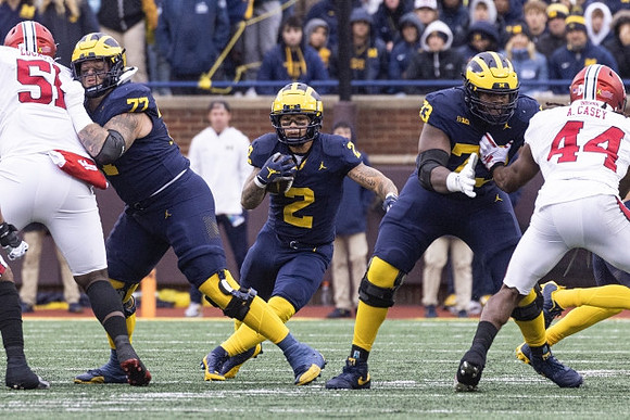 Trevor Keegan (77), Blake Corum (2), and LaDarius Henderson (73)