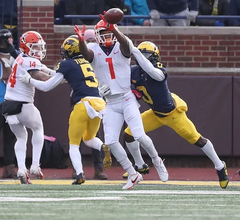 DJ Turner (5) and Mike Sainristil (0)