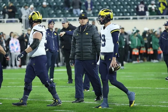Greg Crippen (51), Jim Harbaugh, and J.J. McCarthy (9)