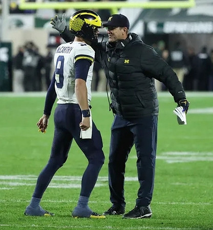 J.J. McCarthy (9) and Jim Harbaugh