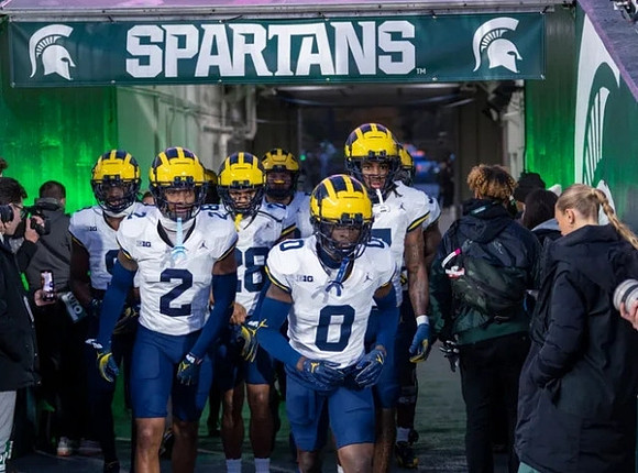 Will Johnson (2), Mike Sainristil (0), and Michigan Team