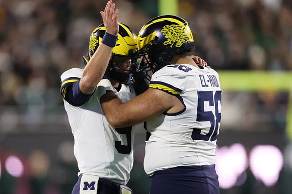 J.J. McCarthy (9) and Giovanni El-Hadi (58)