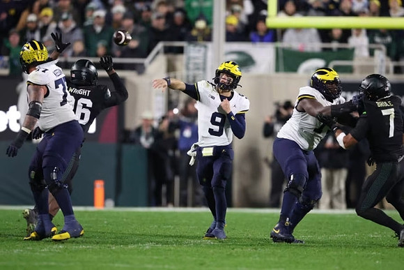 Trevor Keegan (77), J.J. McCarthy (9), and LaDarius Henderson (73)