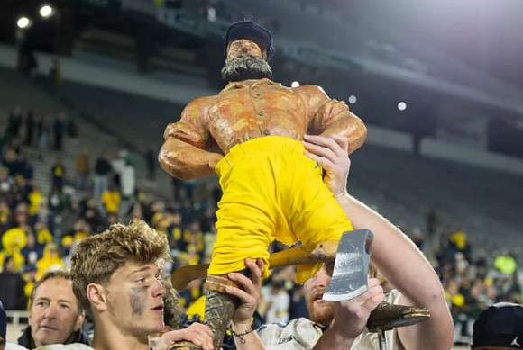 J.J. McCarthy (9) and Paul Bunyan Trophy