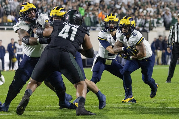 Trevor Keegan (77), J.J. McCarthy (9), and Blake Corum (2)