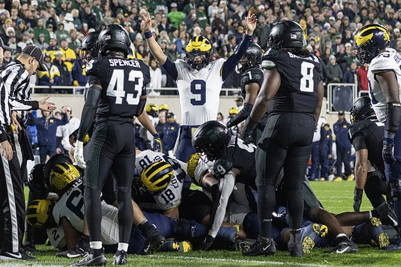 Zak Zinter (65), Colston Loveland (18), J.J. McCarthy (9), and LaDarius Henderson (73)