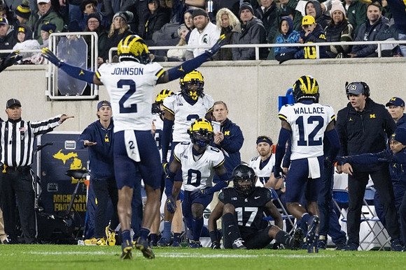 Will Johnson (2), Mike Sainristil (0), and Josh Wallace (12)
