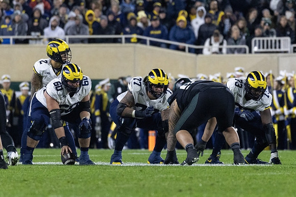 Blake Corum (2), Drake Nugent (60), Trevor Keegan (77), and LaDarius Henderson (73)