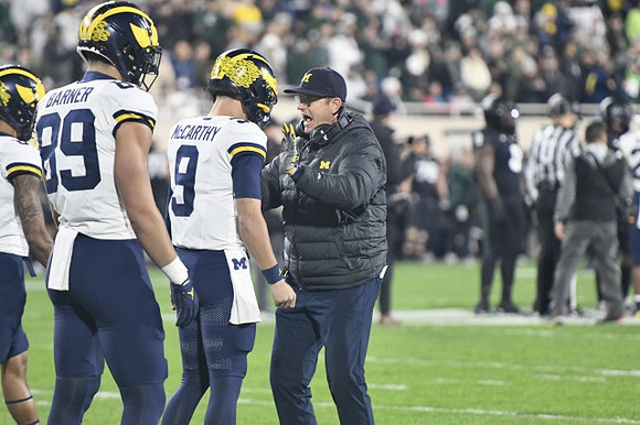 AJ Barner (89), J.J. McCarthy (9), and Jim Harbaugh