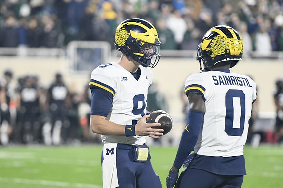 J.J. McCarthy (9) and Mike Sainristil (0)