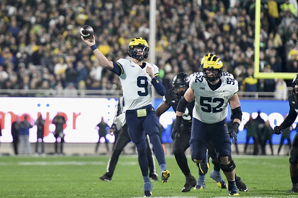 J.J. McCarthy (9) and Karsen Barnhart (52)