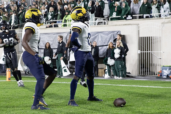Josaiah Stewart (5) and Mike Sainristil (0)