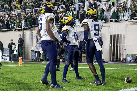 Josaiah Stewart (5), Mike Sainristil (0), and Rod Moore (9)