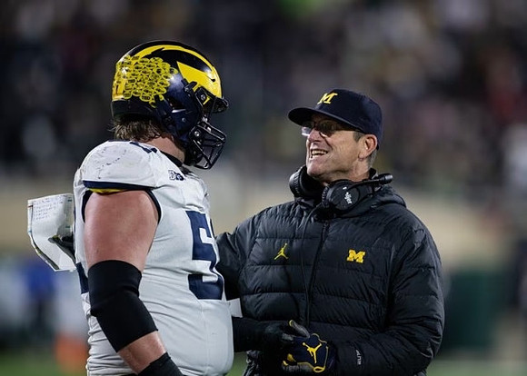 Karsen Barnhart (52) and Jim Harbaugh