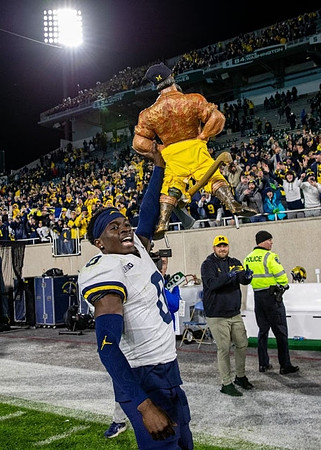 Mike Sainristil (0) and Paul Bunyan Trophy