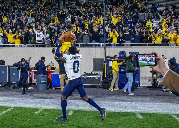 Paul Bunyan Trophy and Mike Sainristil (0)